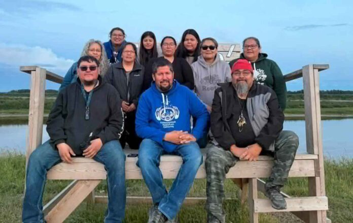 UTNS-KattawapiskakKeekehwinGathering2026-Committee-JKat photo provided by Joseph Kataquapit The Kattawapiskak Keekehwin Gathering committee are a dedicated group of volunteer community members who worked throughout the year to organize the 2026 event which was held from August 2 to 8, 2026. In back L-R are: Linda Kataquapit, Anna Keboke, Flora Iahtail, Lydia Linklater, Fiona Spence, Markiesha Sutherland, RoseAnne Sutherland and Jenny Hookimaw. In front L-R are: Xavier Rose, Joseph (Joojep) Kataquapit and Christopher Kataquapit.