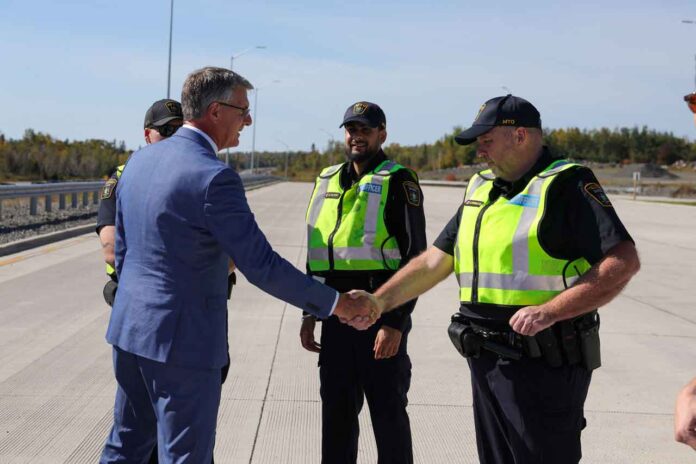 Minister Kevin Holland with MTO Officers